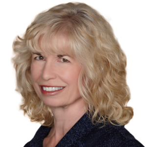 A woman with blonde, curly hair smiles in a dark top, representing Rocky Mountain Commercial Real Estate brokers.
