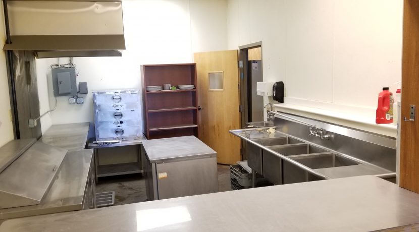 Commercial kitchen space featuring stainless steel countertops, sinks, and storage, suitable for retail food operations in Valley View Plaza, Delta, CO.