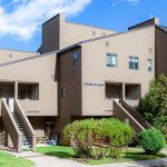 Multi-unit residential building with modern design and greenery, part of Rocky Mountain Commercial Real Estate insights.