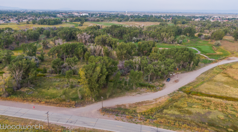 Aerial view of 50 acres of prime development land in Alamosa, Colorado, featuring platted single-family lots, trees, and nearby Cattails Golf Course, showcasing investment potential with scenic surroundings.