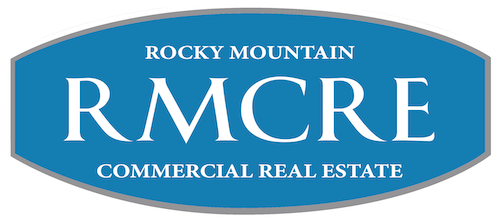 Rocky Mountain Commercial Real Estate logo featuring "RMCRE" in bold white letters on a blue background, representing the organization's branding and services in commercial real estate.