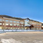 Snow-covered commercial property in Alamosa, Colorado, showcasing modern architectural design and large windows.