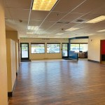Spacious commercial retail building interior with high ceilings, large windows, and polished floors in Ridgway, Colorado.