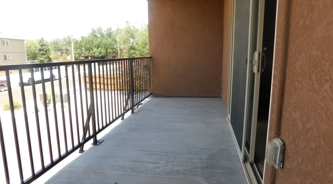 Balcony view of modern townhome at 1534 Poplar Drive, featuring railing, concrete flooring, and access to interior space, highlighting residential outdoor living in Grand Junction, Colorado.
