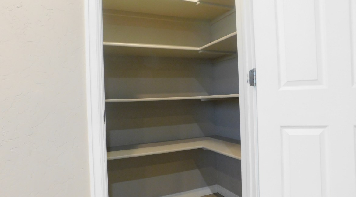 Corner closet with multiple shelves, featuring a clean, modern design, suitable for the contemporary townhomes at 1534 Poplar Drive, Grand Junction, CO.