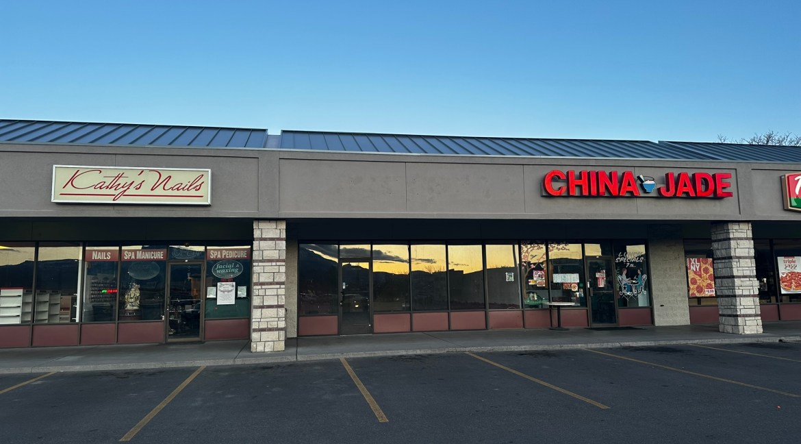 Retail storefronts at Coronado Plaza Shopping Center, featuring "Kathy's Nails" and "China Jade," with visible signage and large windows, located in Clifton, Colorado.